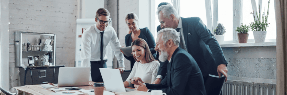 Senior leaders reviewing information together, representing organisations seeking clarity and direction during CRM transition.